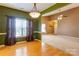 Inviting dining room with hardwood floors, an elegant chandelier, and a large window for natural light at 10927 Chrudan Dr, Charlotte, NC 28262