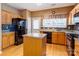 Cozy eat-in kitchen featuring an island, modern appliances, and a window at 10927 Chrudan Dr, Charlotte, NC 28262