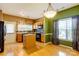 Bright eat-in kitchen with wood cabinets, a center island, and modern appliances at 10927 Chrudan Dr, Charlotte, NC 28262