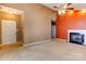 Cozy living room featuring a fireplace, neutral carpet, and ample natural light from a front door at 10927 Chrudan Dr, Charlotte, NC 28262