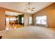 Inviting living room with hardwood and neutral carpet flooring and access to an open-concept kitchen at 10927 Chrudan Dr, Charlotte, NC 28262