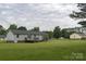 Wide exterior view of a single story home with a gray roof and a wooden deck at 1274 Carpenter Springs Dr, Dallas, NC 28034