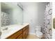 Well-lit bathroom with double sinks, vanity, large mirror, and shower with curtain at 1274 Carpenter Springs Dr, Dallas, NC 28034