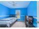 Bedroom featuring bright blue walls, ceiling fan, and a large window at 1274 Carpenter Springs Dr, Dallas, NC 28034
