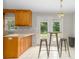 Kitchen eating area, with wooden cabinets, breakfast bar, and a door to deck at 1274 Carpenter Springs Dr, Dallas, NC 28034