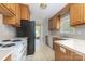 Functional kitchen featuring wooden cabinets, ample counter space, and view to backyard at 1274 Carpenter Springs Dr, Dallas, NC 28034
