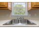 Close-up of kitchen sink, showcasing stainless steel fixtures and a window view at 1274 Carpenter Springs Dr, Dallas, NC 28034