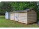 Two storage sheds sit on a grassy lot surrounded by mature trees at 1274 Carpenter Springs Dr, Dallas, NC 28034