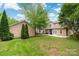 Well-maintained backyard with a sunroom and a detached garage at 14034 Cedar Pond Cir, Huntersville, NC 28078