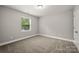 Bedroom with neutral paint, carpeted floor and a window with outside view at 14034 Cedar Pond Cir, Huntersville, NC 28078