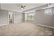 Spacious bedroom with a ceiling fan, large windows, and an ensuite bathroom at 14034 Cedar Pond Cir, Huntersville, NC 28078