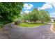 Long driveway leading to a house with a beautiful landscape at 14034 Cedar Pond Cir, Huntersville, NC 28078