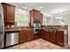 Well-equipped kitchen with stainless steel appliances, granite countertops, and tile flooring at 14034 Cedar Pond Cir, Huntersville, NC 28078