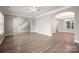 Open-concept living room with hardwood floors, archways, and staircase at 14034 Cedar Pond Cir, Huntersville, NC 28078