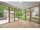 Enclosed sunroom with wood framing and backyard views at 14034 Cedar Pond Cir, Huntersville, NC 28078