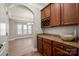 Stylish wet bar featuring granite countertops and custom cabinetry at 14034 Cedar Pond Cir, Huntersville, NC 28078