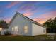 Back of the home with vinyl siding in a well-maintained yard at dusk at 1623 Martin Ave, Gastonia, NC 28052