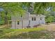 Expansive backyard features a covered patio, lush lawn and white brick exterior at 1814 Brookdale Ave, Charlotte, NC 28210