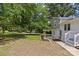 Spacious backyard featuring green grass, mature trees and a covered patio at 1814 Brookdale Ave, Charlotte, NC 28210