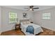 Inviting bedroom with natural light from two windows, stylish decor, and a ceiling fan at 1814 Brookdale Ave, Charlotte, NC 28210