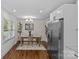 Bright dining area features hardwood floors, modern lighting, and a view to the front yard at 1814 Brookdale Ave, Charlotte, NC 28210