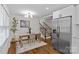 Open dining room with hardwood floors, and a stainless refrigerator at 1814 Brookdale Ave, Charlotte, NC 28210