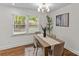 Sunlit dining room featuring modern chandelier, hardwood floors, and a charming decor at 1814 Brookdale Ave, Charlotte, NC 28210