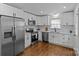 Kitchen featuring stainless appliances, white cabinets and countertops, and hardwood floors at 1814 Brookdale Ave, Charlotte, NC 28210