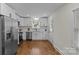 Well-lit kitchen with white cabinets, stainless steel appliances, and hardwood floors at 1814 Brookdale Ave, Charlotte, NC 28210