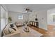Bright living room features hardwood floors, modern decor, a ceiling fan and ample natural light at 1814 Brookdale Ave, Charlotte, NC 28210