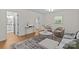Bright living room featuring hardwood floors, neutral walls, stylish furniture, and an ensuite bathroom at 1814 Brookdale Ave, Charlotte, NC 28210