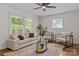 Bright living room features hardwood floors, modern decor, a ceiling fan and ample natural light at 1814 Brookdale Ave, Charlotte, NC 28210