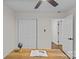 Office area featuring white closet doors, hardwood floors and a ceiling fan at 1814 Brookdale Ave, Charlotte, NC 28210