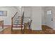 Elegant staircase features wooden steps with white risers, contrasted with dark metal railings at 1814 Brookdale Ave, Charlotte, NC 28210
