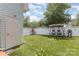 Serene backyard featuring a swing with canopy, surrounded by a well-kept lawn and privacy fence at 186 Gresham Ln, Mooresville, NC 28117