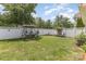 Inviting backyard featuring a cozy swing, lush green lawn, and well-maintained white fence, perfect for relaxation at 186 Gresham Ln, Mooresville, NC 28117
