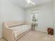 Inviting bedroom featuring a daybed with a floral quilt, a window, and light, neutral decor at 186 Gresham Ln, Mooresville, NC 28117