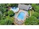 Aerial view of community pool featuring pools, slide, lounge chairs, pergola and lush landscaping at 186 Gresham Ln, Mooresville, NC 28117