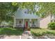 Charming two-story home featuring a welcoming front porch, red door, and an American flag waving proudly at 186 Gresham Ln, Mooresville, NC 28117