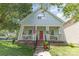 Inviting two-story home with light blue siding, red door, front porch, and manicured lawn at 186 Gresham Ln, Mooresville, NC 28117