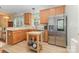 Spacious kitchen featuring stainless steel appliances, wood cabinets, and a large island with wooden frame at 186 Gresham Ln, Mooresville, NC 28117