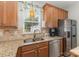 Updated kitchen featuring stainless steel appliances, wood cabinets, and granite countertops at 186 Gresham Ln, Mooresville, NC 28117