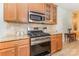 Well-equipped kitchen featuring stainless steel appliances, granite countertops, and wooden cabinets at 186 Gresham Ln, Mooresville, NC 28117