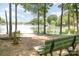 Scenic lake view with a bench, lush trees, and serene water, creating a peaceful outdoor escape at 186 Gresham Ln, Mooresville, NC 28117