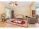 Comfortable living room with a ceiling fan, hardwood floors, and a mix of modern and antique furniture at 186 Gresham Ln, Mooresville, NC 28117