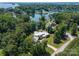 Aerial view of house surrounded by mature trees, and lake at 188 Blarney Rd, Mooresville, NC 28117