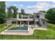 Beautiful backyard featuring a sleek pool, hot tub, and covered patio with stunning architecture at 188 Blarney Rd, Mooresville, NC 28117