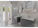 A primary bathroom features double vanities, designer mirrors, and access to a luxurious outdoor shower at 188 Blarney Rd, Mooresville, NC 28117