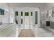 A luxurious primary bath boasts a soaking tub and an outdoor shower room surrounded by frameless glass windows at 188 Blarney Rd, Mooresville, NC 28117