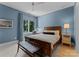 A peaceful bedroom features a light blue wall, a wooden bed and bench with a window view at 188 Blarney Rd, Mooresville, NC 28117